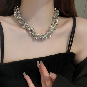 Close-up of a silver multi-strand metallic bead choker with twisted layering details