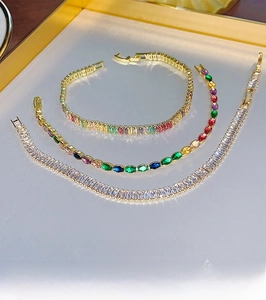 Detailed close-up of three gold-plated bracelets featuring colorful and clear zircon stones