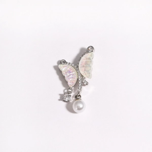 Detail of silver butterfly earring with opal wings, zircon accents and hanging pearl