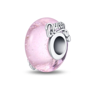 Detailed macro view of pink glass charm bead with silver core featuring Queen engraving