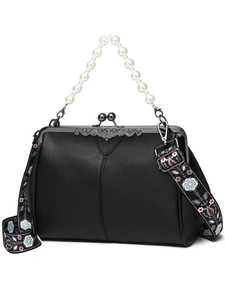 Detail of vintage black kiss-lock bag with pearl handle and ethnic pattern strap
