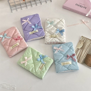 Flat lay of quilted ribbon passport holders in pink, purple, white, green and blue colors
