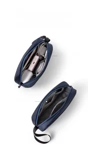Detail of blue digital organizer bag showing large capacity storage for cables and power bank