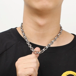 Silver stainless steel chain necklace with square pearls worn by a model on black t-shirt