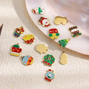 Detailed assortment of colorful Christmas enamel charms with gold frames on a shell