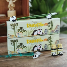 Detailed view of bamboo-shaped glass dip pen set with panda theme and ink bottles