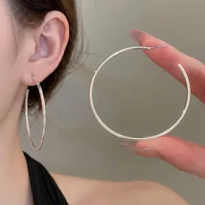 Minimalist silver geometric C-shaped hoop earrings with large round silhouette for women