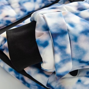 Detail of blue and white marble pattern jacket with black windproof elastic cuffs