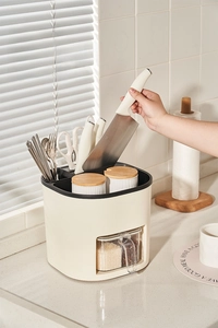 Detail view of a multifunctional cream kitchen organizer with knife slots and spice jars