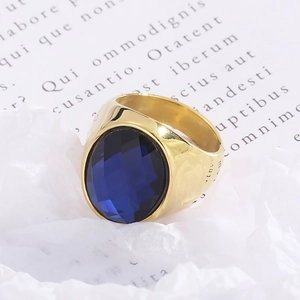Detailed macro view of an oval blue gemstone set in a vintage gold-plated titanium ring