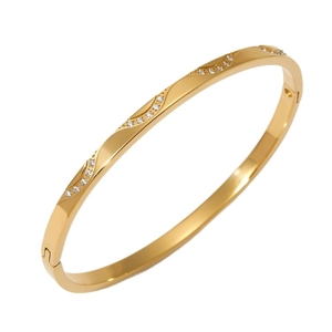 Elegant gold stainless steel bangle featuring wave patterns and sparkling crystals