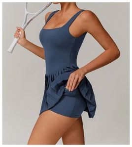 Detail showing side pocket of dark blue pleated tennis dress with built-in shorts