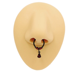 Detail showing a black bat septum ring with a red teardrop zircon on a nose model