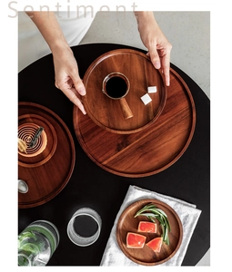 Detail of round wooden serving tray set with natural wood grain texture for dessert