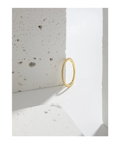 Detailed view of an eternity ring with white zircons set in a minimalist gold band