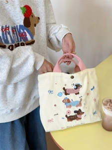 Simpatica borsa in velluto a coste beige con manici rosa e ricamo di bassotti per il pendolarismo
