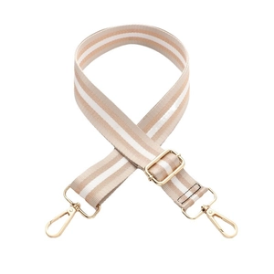 Adjustable beige striped canvas shoulder strap with gold metal hardware on white background