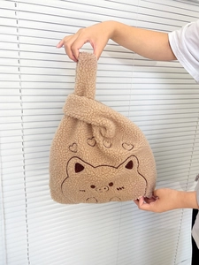 Detailed view of brown teddy fleece handbag with cute animal embroidery and heart pattern