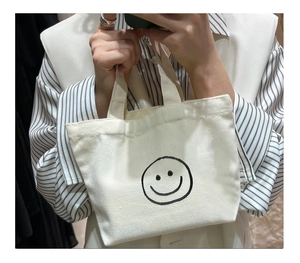 Detailed macro shot of durable off-white canvas material with a black printed smiley face