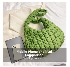 Detailed top view of the green quilted hobo bag compared with a tablet for size reference