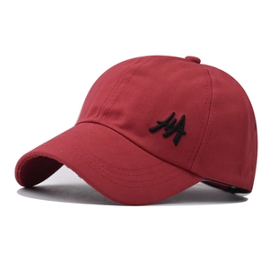 Detail showing the dark red cotton fabric texture and black AA embroidery on baseball cap
