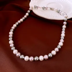 Elegant multi-color pearl necklace with white, lavender and grey pearls on red silk