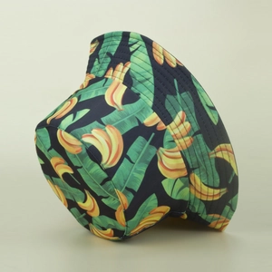 Detail of banana print bucket hat showing yellow tropical fruit pattern and flat brim stitching