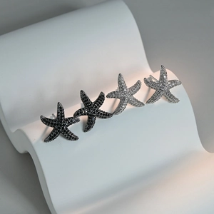 Micro-pave starfish earrings in black and white zirconia with a silver metal base