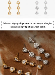 Detail showing high polish 316L stainless steel and zircon triple heart drop earrings