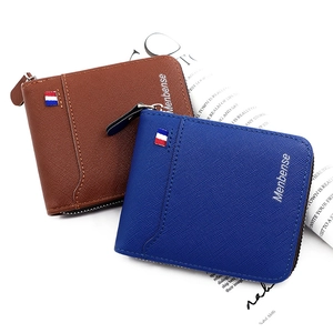 Close-up of brown and blue crosshatch leather wallets with zippers and ribbon detail
