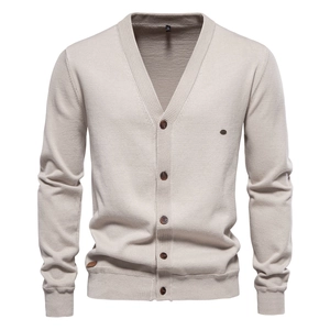 Close-up of beige V-neck knitted cardigan with ribbing details and buttons