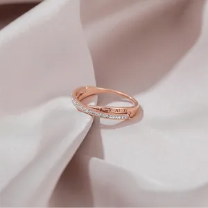 Rose gold roman numeral double band cross ring with cubic zirconia on silk backdrop