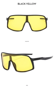 Detail of oversized black cycling sunglasses with yellow lenses showing front and side views