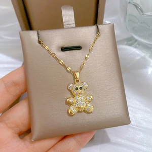 Close-up of luxury gold bear pendant necklace with sparkling crystals on jewelry card