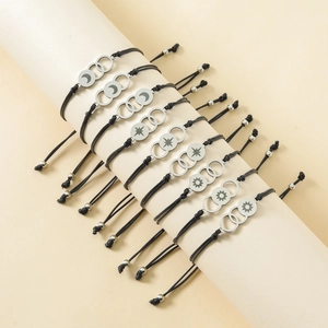 Adjustable woven sun moon and star bracelets made of stainless steel on a display stand