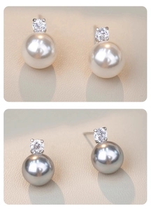 Detailed view of large natural freshwater pearls in white and grey colors with sparkling zircon