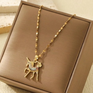Golden stainless steel unicorn pendant necklace with colorful cubic zirconia on jewelry box