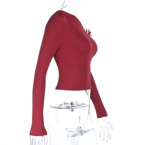 Side view of fitted dark red long sleeve crop top in ribbed knit on a mannequin