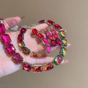 Macro view of crystal rhinestone necklace and earring set with pink and rainbow gemstones
