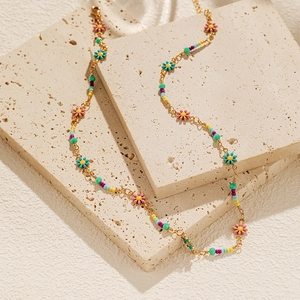 Detail of colorful beads and daisy flower pendants on a bohemian choker necklace