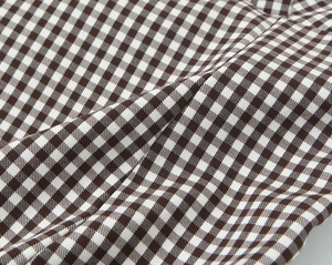 Detailed macro view of brown and white checkered fabric with a fine woven texture