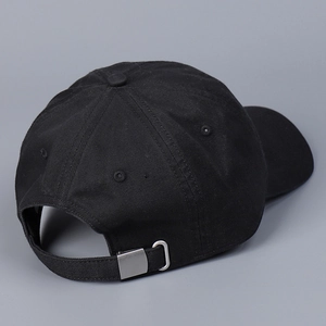 Detail view of cotton baseball cap with adjustable metal buckle and breathable eyelets