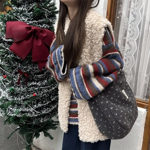 Plush tote bag with white polka dots paired with winter vest and striped sweater