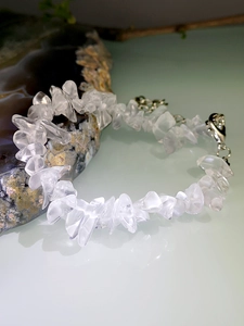 Macro detail of natural irregular white crystal stone bracelet with silver lobster clasp