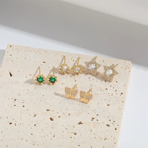 Set of 4 gold star and butterfly earrings with green and white cubic zirconia