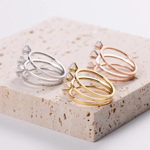Three-layer classic rings set in silver, gold, and rose gold with marquise-cut crystals
