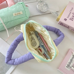 Detail of soft padded stationery pouches with handles and interior storage space