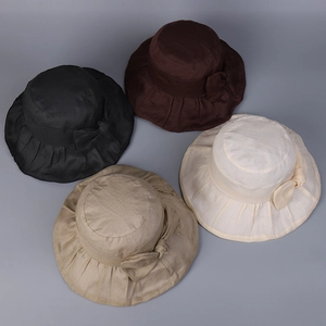 Detail view of linen sun hats in four colors with pleated brims and bow decorations