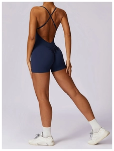 Detail of dark blue backless athletic romper with cross straps and scrunched booty lift