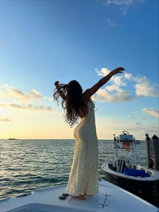 Elegant backless lace maxi dress in cream white with deep V-neck for summer vacations